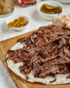 close up of lamb kebab meat served with flatbread